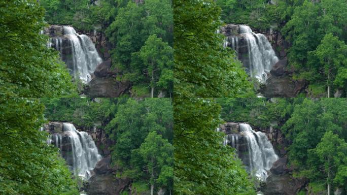 令人惊叹的夏季景观，在南塔哈拉国家森林的巨石之间，森林河水在清澈的大瀑布中倾泻而下。美国北卡罗来纳州