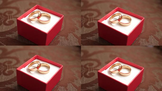 红盒子里的金结婚戒指。婚礼仪式。