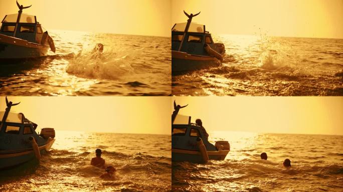 SLO MO -时间扭曲效果/速度斜坡剪影夫妇一起跳从船上到海水在日落
