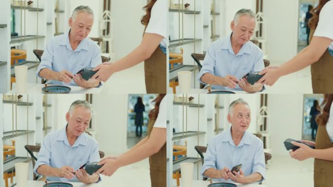 一位年长的亚洲男性顾客在现代咖啡馆用智能手机进行移动支付，展示了现代支付的便利性。小企业主。