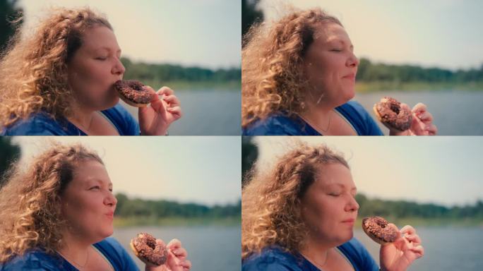大码女人在公园吃甜甜圈的特写，暴食的问题