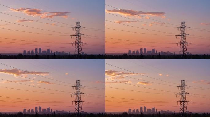 城市电力塔为城市提供能源。在色彩斑斓的早晨，昂首挺立。云在空中平稳地移动。延时云景自然能源与环境概念