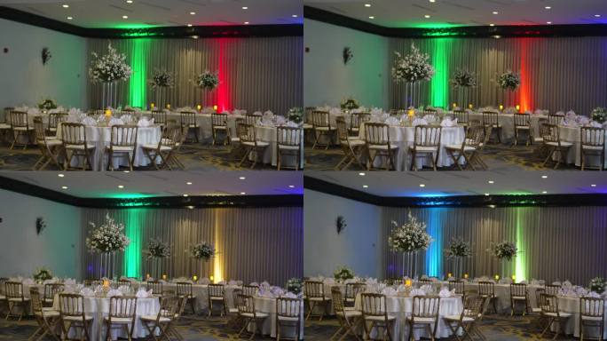 酒店的会议室，色彩缤纷，优雅，为婚宴庆典而装饰，圆桌上高高的中心装饰品，花和白玫瑰。