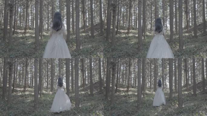 美女穿着婚纱慢慢走进林中