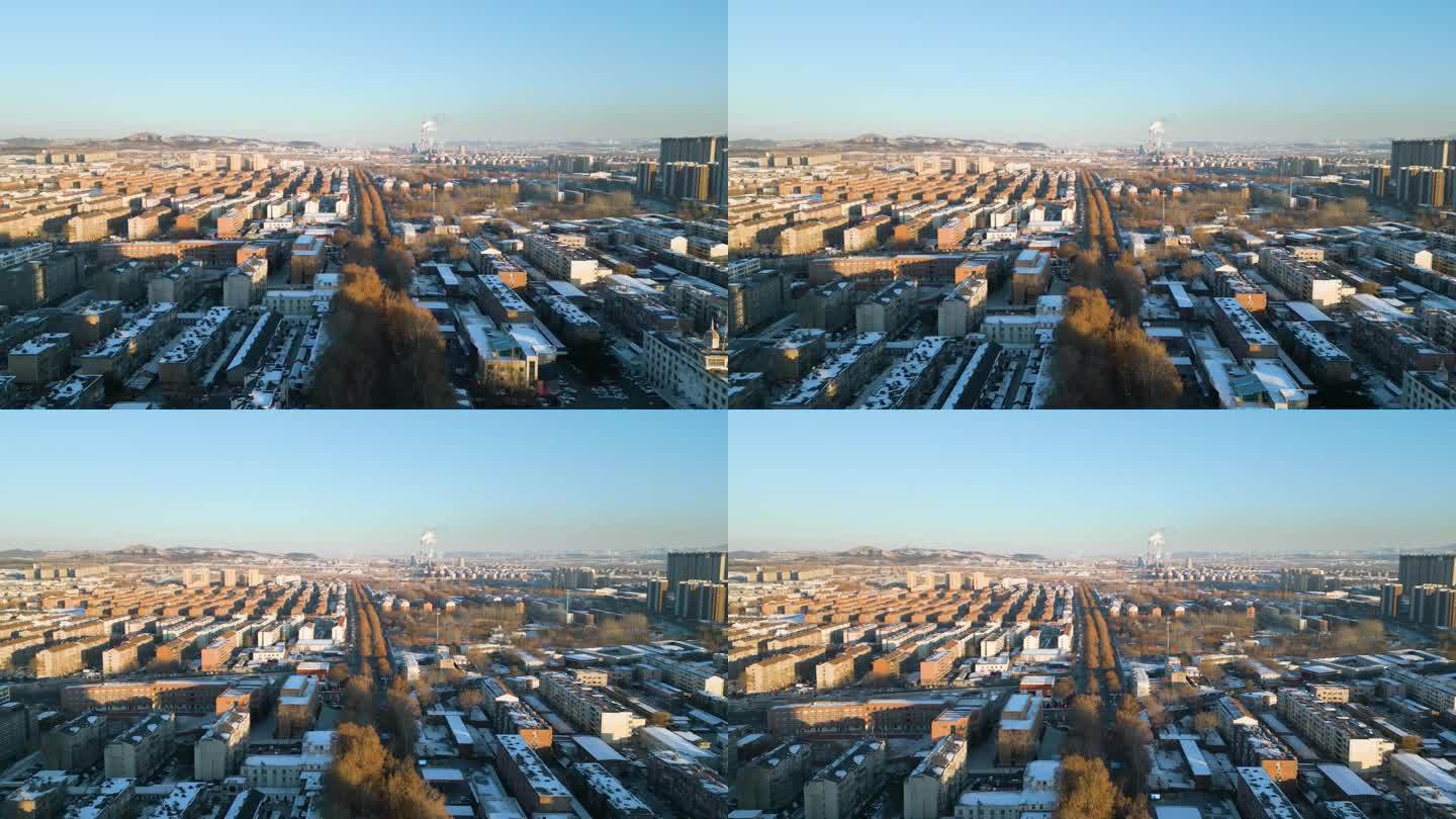 这张鸟瞰图捕捉到了中国山东省淄博市迷人的冬季日落，背景是发电厂的剪影，展现了一个迷人的场景。