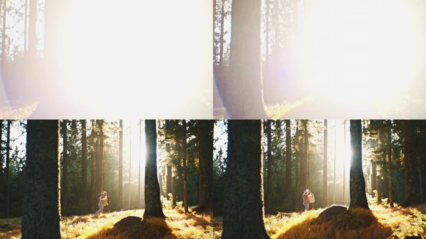 在阳光明媚的秋林里，年轻的女徒步旅行者在树下自拍