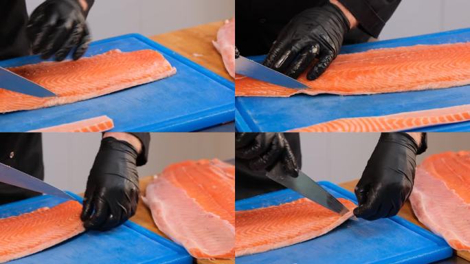 切生三文鱼片。厨师把鱼不能用的部分切掉。