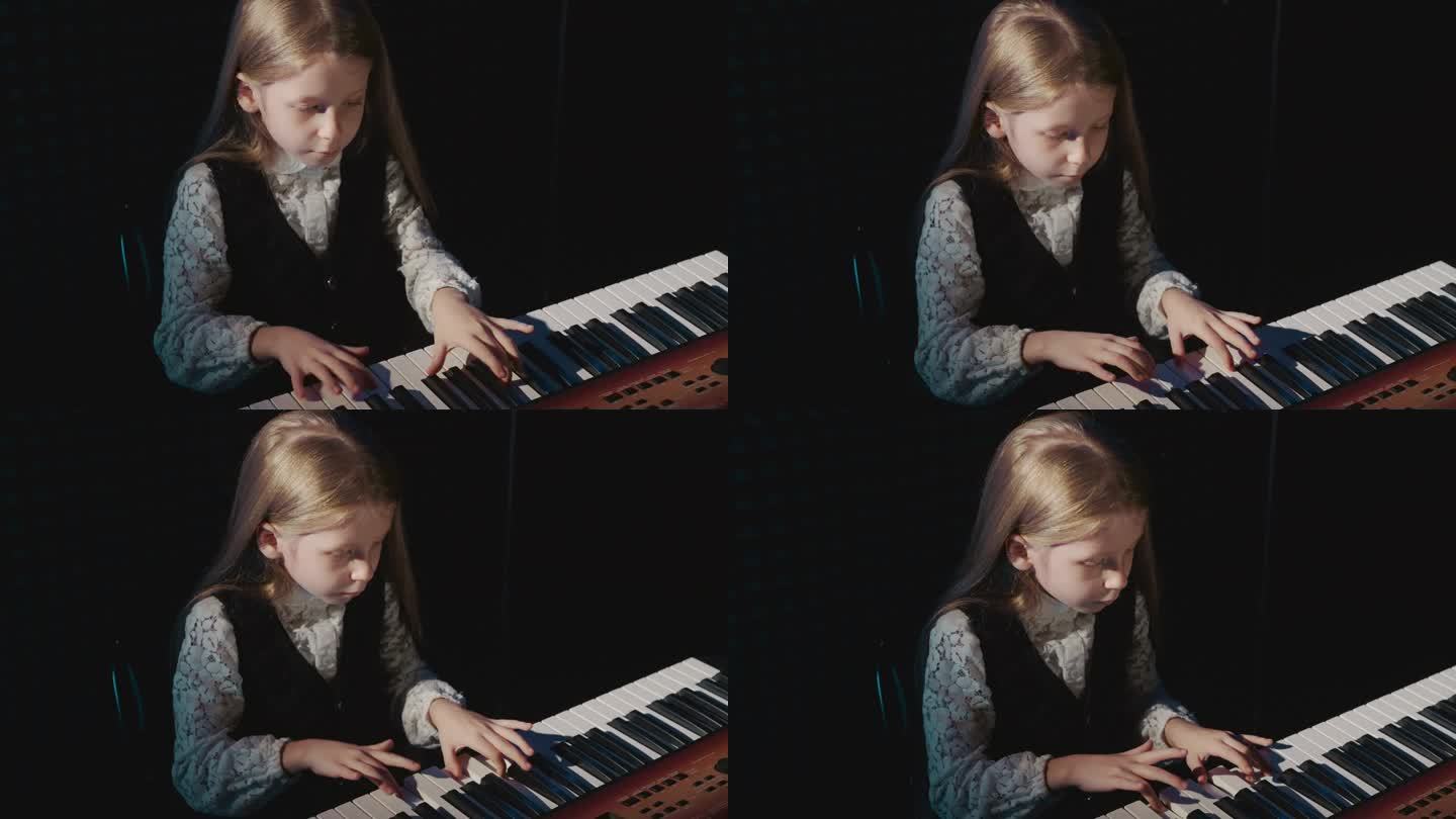 孩子在电子钢琴上弹奏简单的旋律