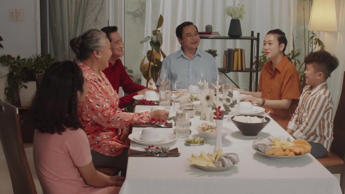 几代同堂的亚洲家庭在晚餐时的交流