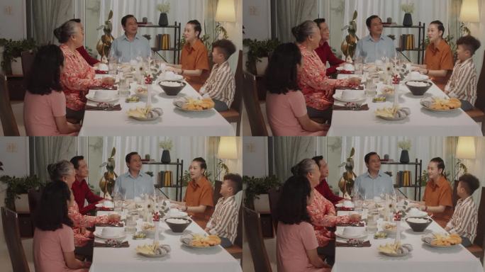 几代同堂的亚洲家庭在晚餐时的交流