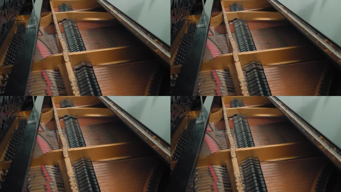 近距离观察锤子和琴弦在直立钢琴内部。