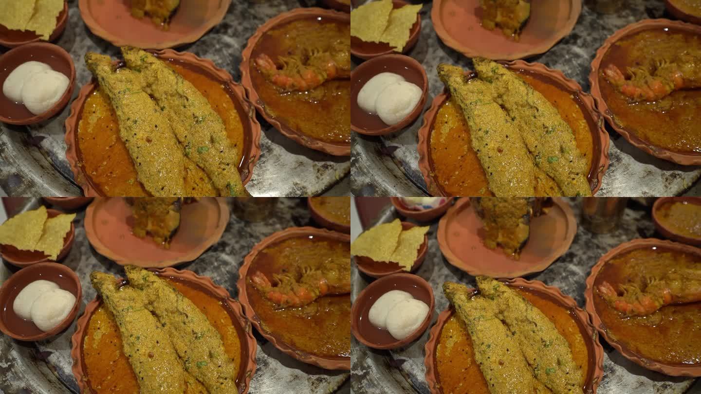 鱼、拉斯古拉斯、对虾、木瓜、酸辣酱和其他一些菜肴的侧面视图，放在青铜玻璃上的粘土和水组成的盘子里。