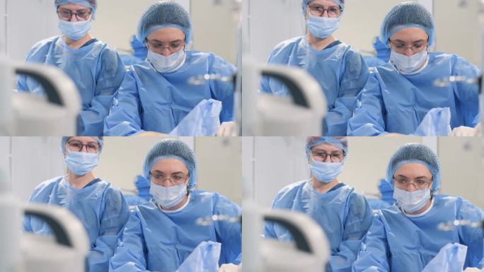 一组外科医生在手术中使用外科腹腔镜器械切除腿部静脉