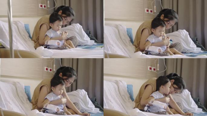 可爱的亚洲孩子感染了病毒，他照顾和使用体温计测量体温由他的母亲接受抗生素药物和输液生理盐水在医院等待