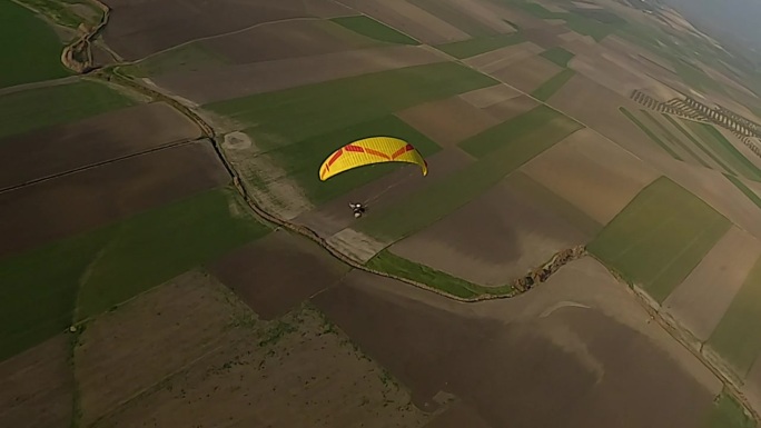 近距离空中飞行经过滑翔伞亮黄色的伞盖