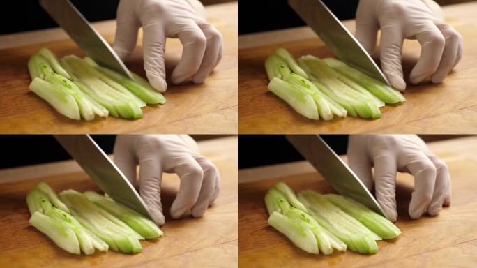 新鲜的黄瓜被切成小块用于烹饪。做黄瓜菜。缓慢的运动。