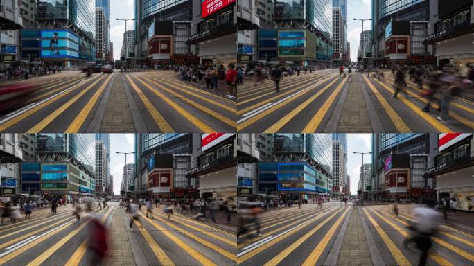 中国人走过香港旺角购物区的斑马线。