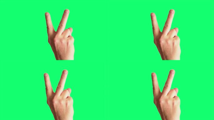 近距离拍摄的一个男性的手轻弹一个经典的V手势侮辱，背景是理想的色度键控绿屏