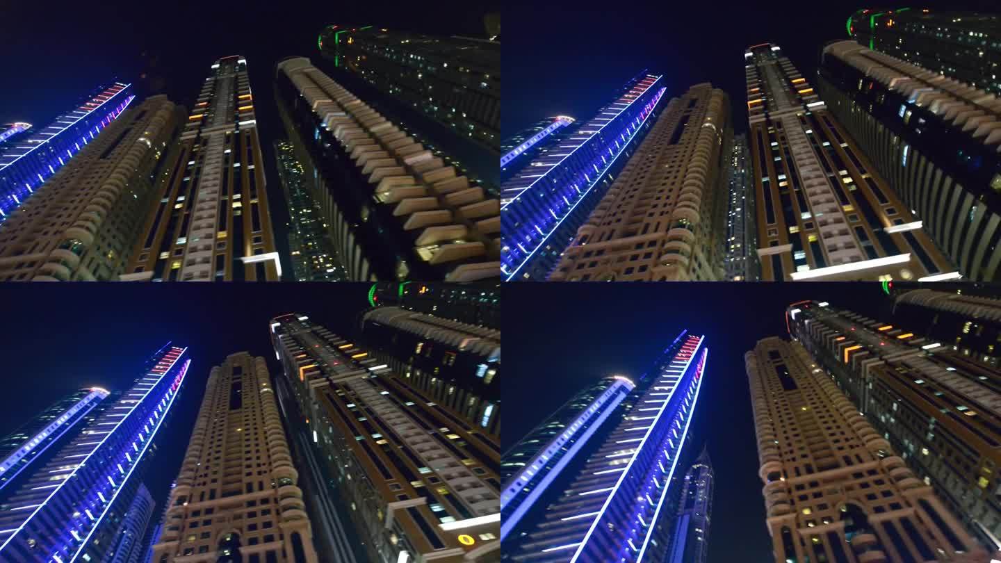 2016年12月5日，阿联酋迪拜:在摩天大楼的灯光下，沿着迪拜码头漫步