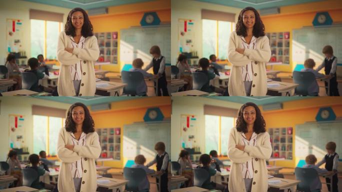 一个美丽快乐的年轻教师站在教室里，双臂交叉，看着镜头，微笑着。多民族妇女在小学工作，照顾天才儿童