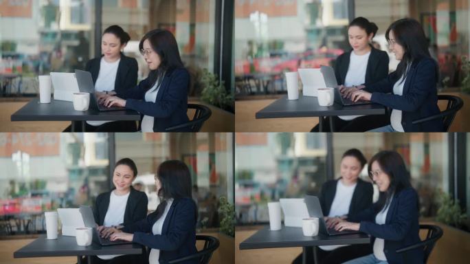 两个漂亮的孕妇在咖啡店里用笔记本电脑讨论图表和数据的侧视图