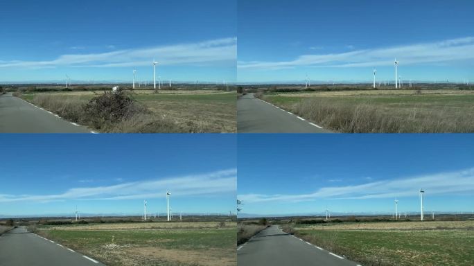大规模风力涡轮机的可持续能源线，从汽车上主观参观。生态转型概念可再生能源气候变化绿色能源。