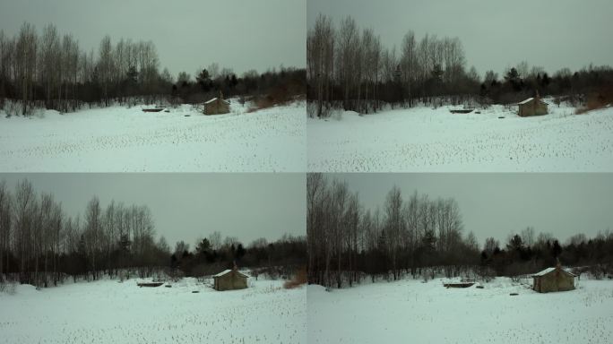 航拍东北冰雪覆盖的乡村农村小屋