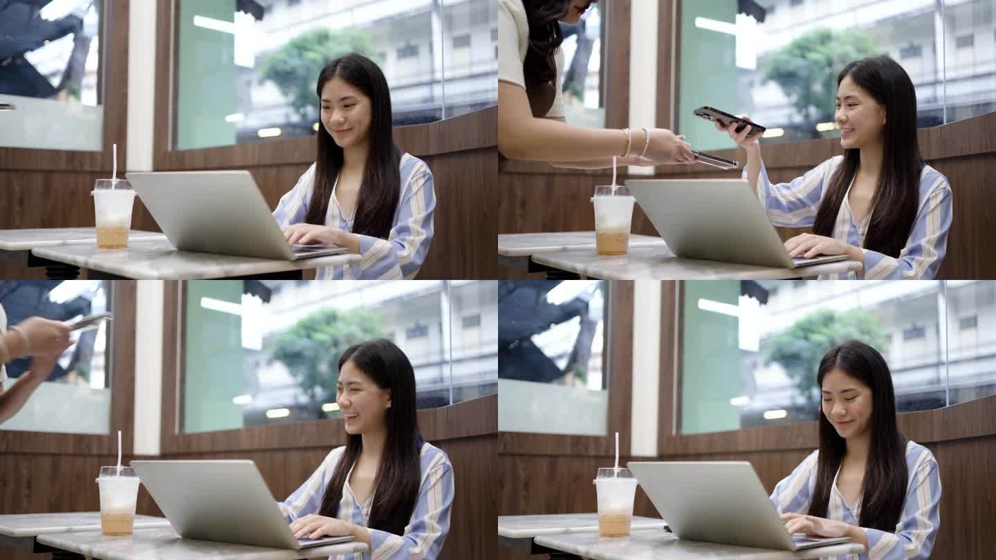 亚洲客户使用智能手机扫描条形码通过银行应用程序与咖啡厅餐厅服务员，无现金二维码技术和汇款概念进行支付
