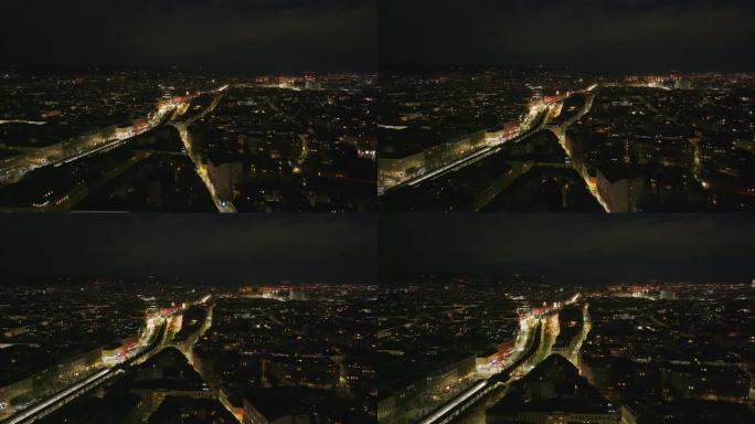 傍晚大都市的航拍全景镜头。街灯和汽车在夜晚发光。奥地利的维也纳