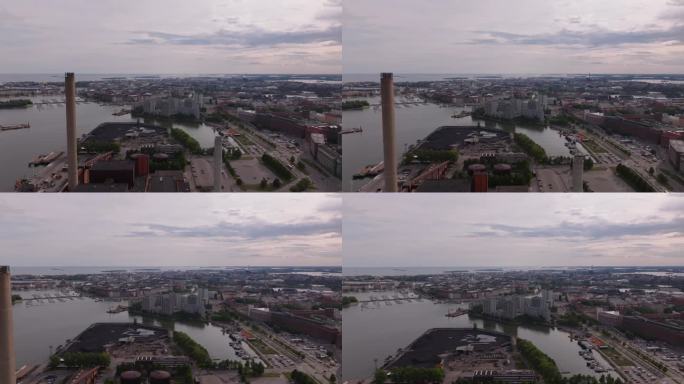 前锋飞过供热厂和码头上的煤仓。沿海大城市的全景。芬兰赫尔辛基