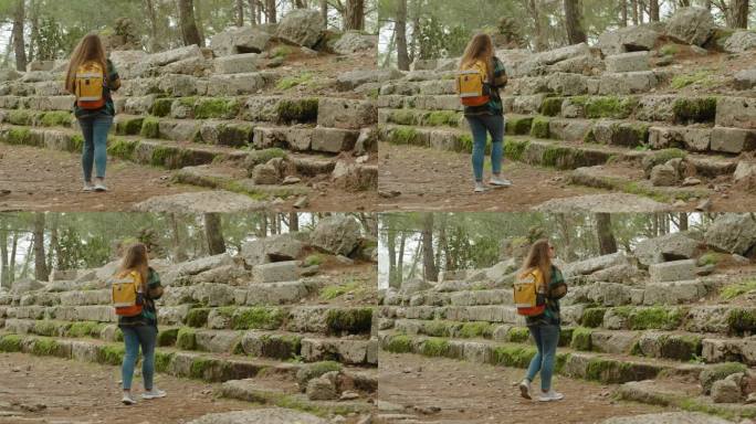 一个背着双肩包的女人的孤独之旅，探索森林中布满青苔的古老台阶和破败的房屋。
