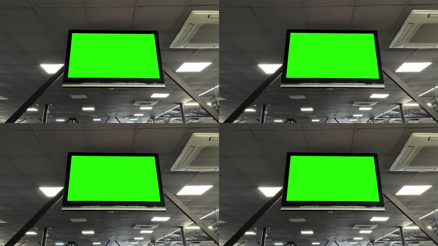 平板电视上的Chromakey绿色屏幕，安装在健身房的天花板上，用于动态内容显示。