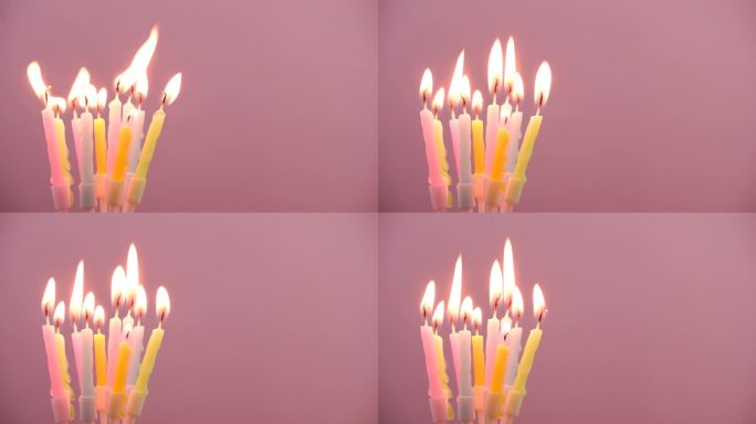 生日蜡烛燃烧在粉红色的背景，文字的复制空间。