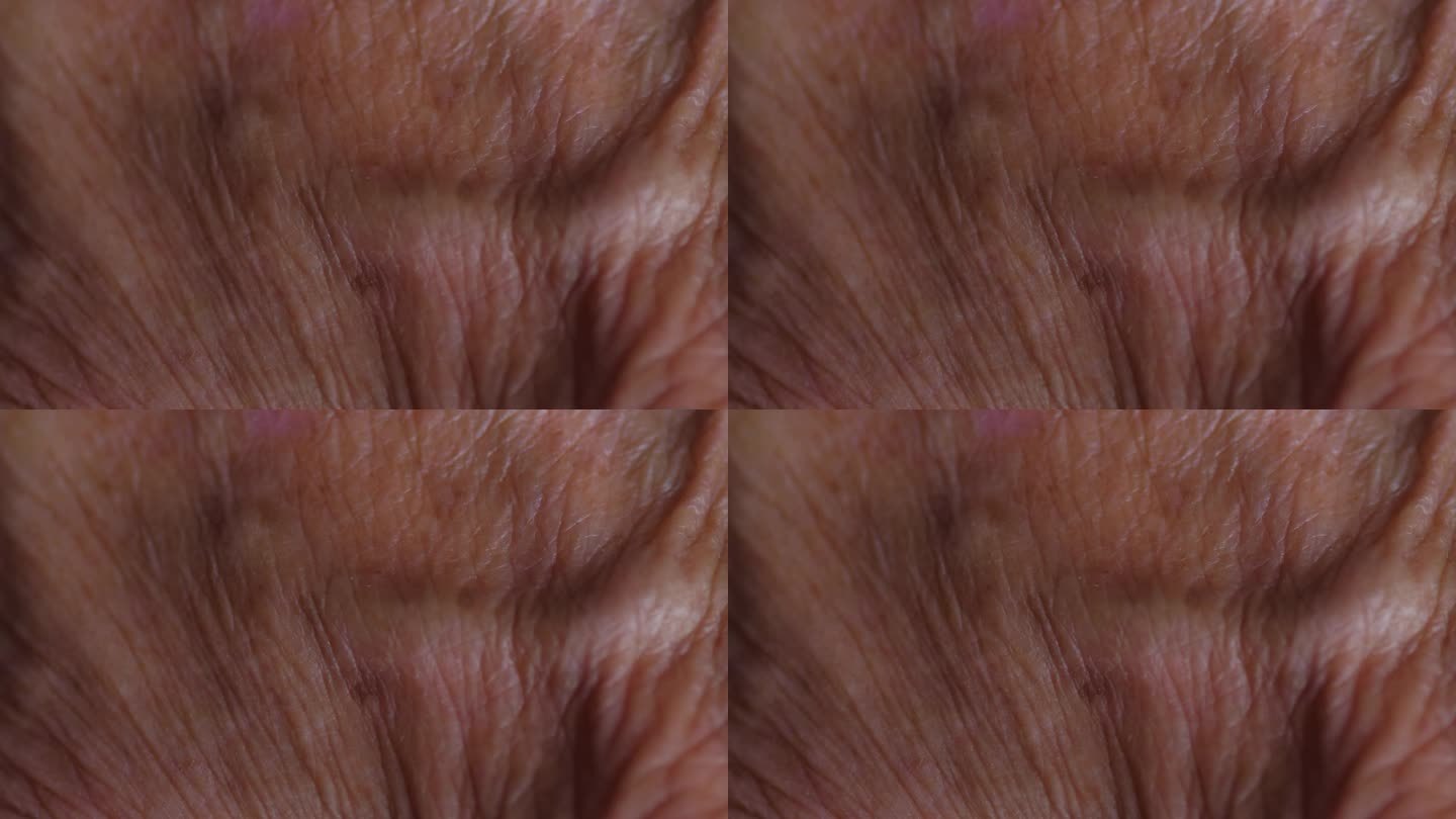 一个老人的皱纹皮肤的特写镜头。有选择性的重点。人体衰老的过程，人体的一部分。养老金领取者的概念