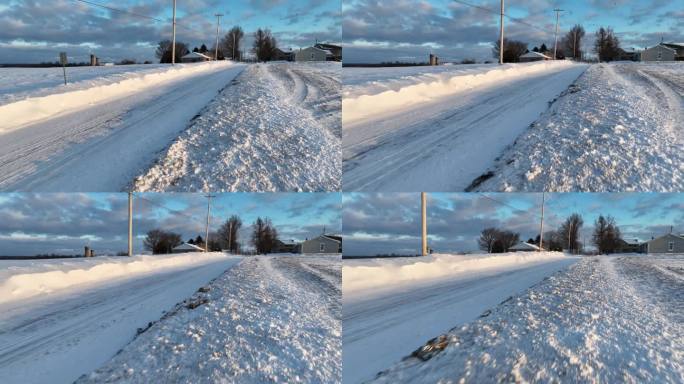 冬雪沿着乡间小路飘来飘去。危险驾驶条件与暴风雪条件在美国乡村农场场景。扫雪机打开街道。鸟瞰图。