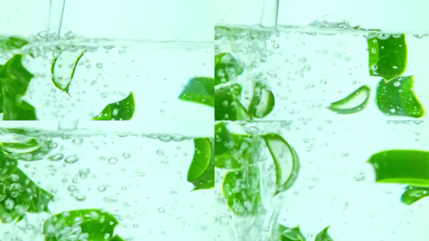 水填满了装有芦荟片的玻璃容器。前视图，慢动作视频。