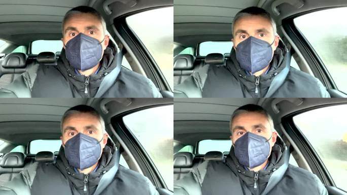 一名男子戴着FFP2口罩开车，试图阻止疾病