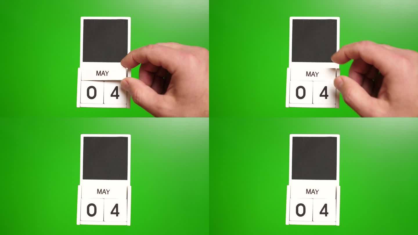 日历上的日期5月4日在一个绿色的背景。说明某一特定日期的事件。