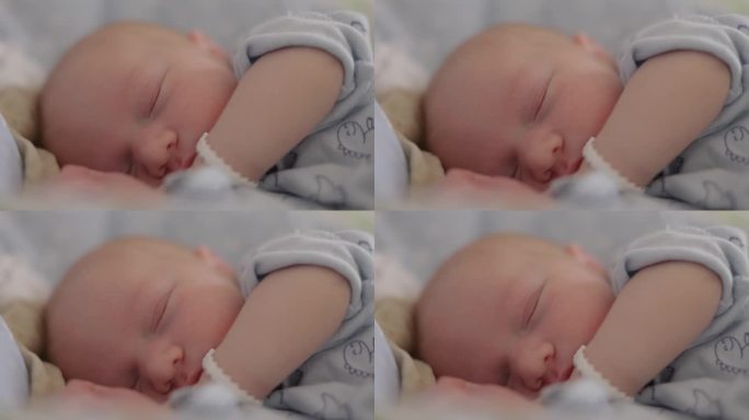 在医院产房熟睡的可爱男婴手持特写镜头。一个带标签的5天大的婴儿