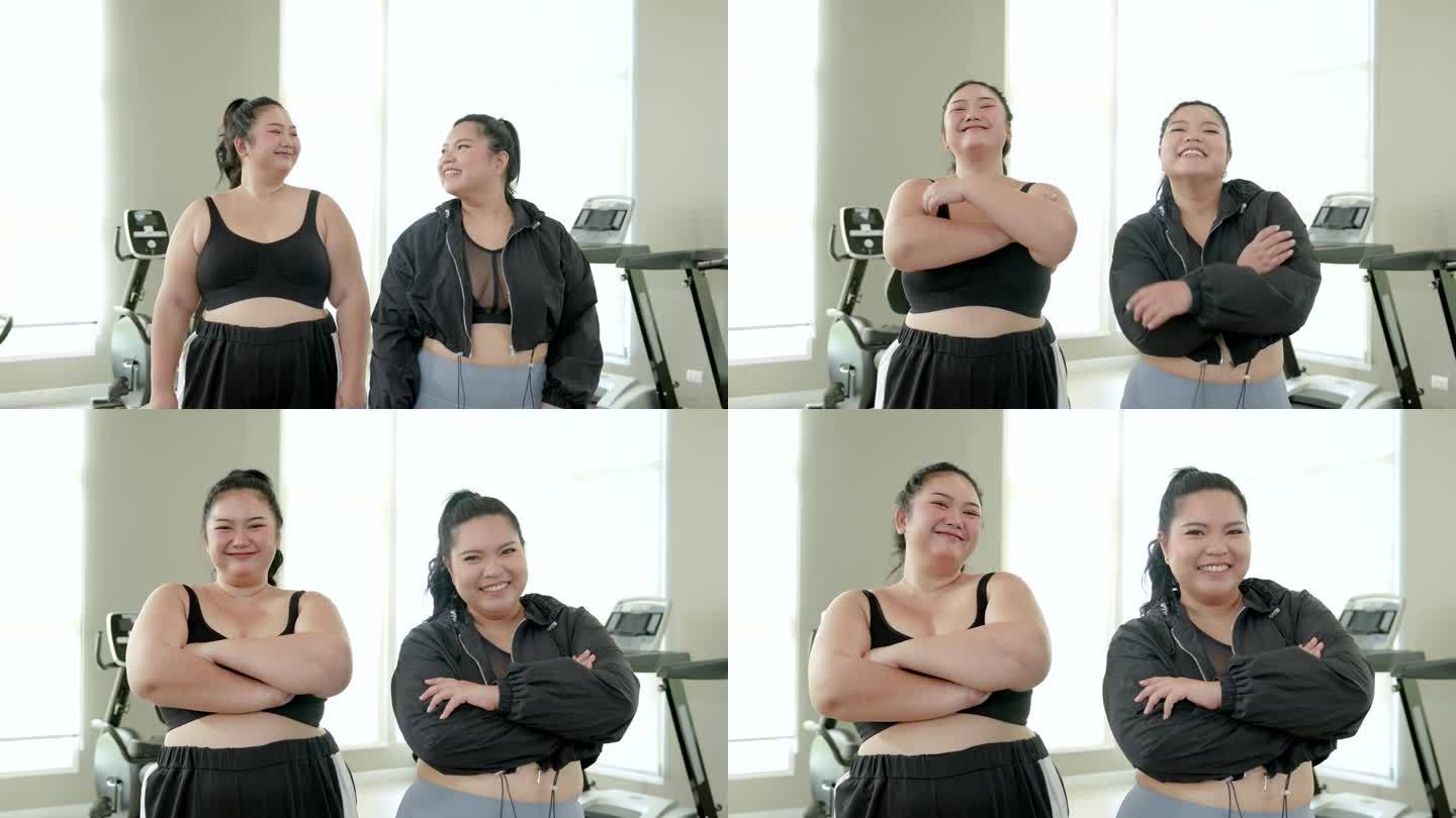 两个胖胖的亚洲女人穿着运动服，在健身房开心地微笑着。两个胖胖的女人有强烈的减肥意愿，健身伙伴，生活方