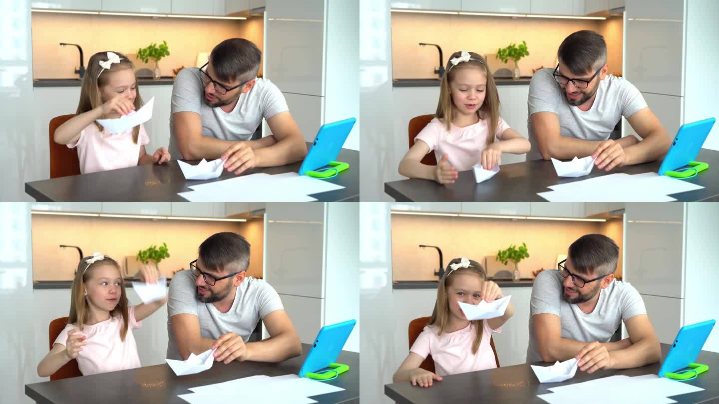 父亲和女儿用平板电脑上的视频教程制作折纸白纸船