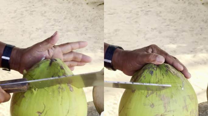 在沙滩上用弯刀开一个椰子