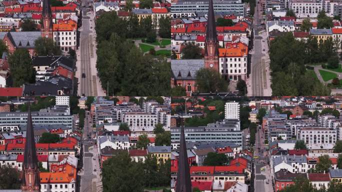 在有电车轨道的街道上缓慢移动的一对汽车的高角度视图。有宽阔步行区的现代化街道。有塔和钟楼的教堂。挪威
