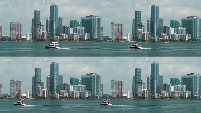 迈阿密布里克尔市中心办公区与豪华游艇航行在佛罗里达州，美国。现代美国大都市的高滨水商业和住宅摩天大楼