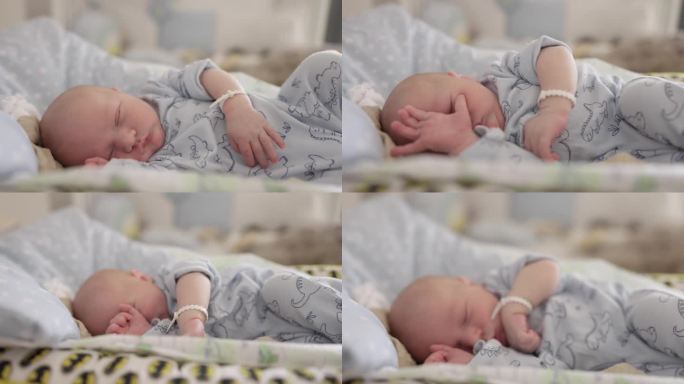在妇产医院病房的婴儿床上熟睡的可爱男婴手持镜头。一个5天大的婴儿第一次在家过夜。从医院回家
