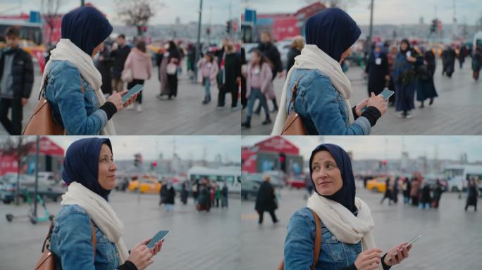 女游客在伊斯坦布尔的某个地方散步时使用她的智能手机