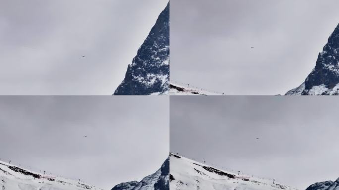 瑞士山地救援直升机在雪上滑雪胜地上空飞行