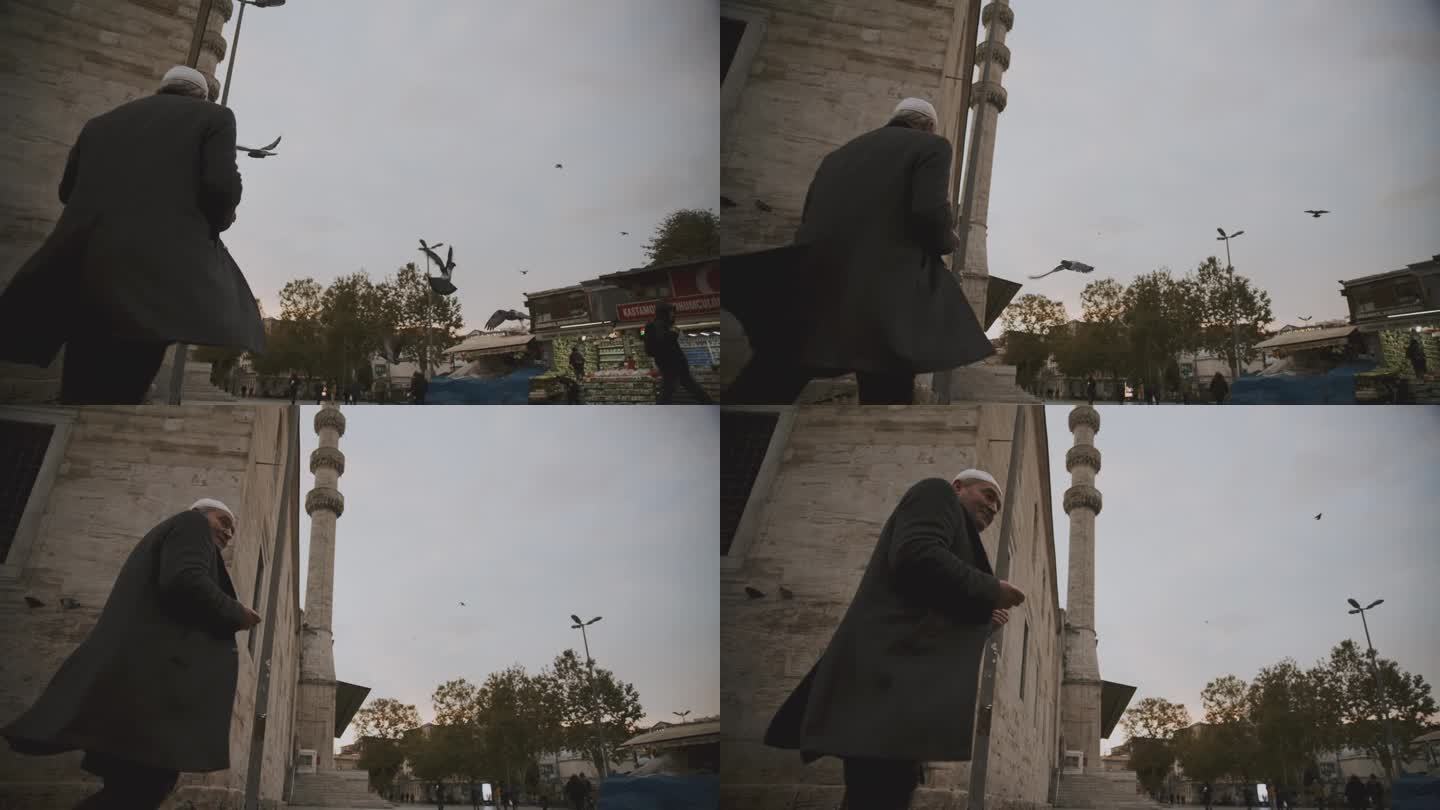 老人沿着清真寺散步，鸽子在清真寺入口处翱翔
