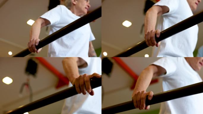 老年妇女倚在双杠上行走，在物理治疗中有点困难
