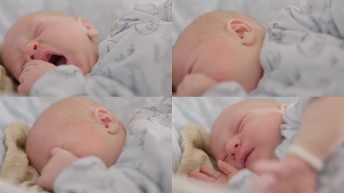 在医院的产科病房里，刚出生的男婴在睡觉时打哈欠和伸懒腰的特写手持镜头。一个5天大的婴儿
